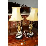 A PAIR OF LATE 19TH CENTURY CONVERTED TABLE LAMPS of a two semi clad putti on a stepped painted