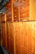 A QUANTITY OF PINE BEDROOM FURNITURE to include three two door wardrobes, one with upper cupboard