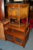 AN OLD CHARM OAK HALL CABINET with a single door together with a matching tea trolley with double