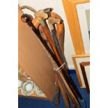 A BUNDLE OF WALKING STICKS, to include carved stick, horses head pommel (sd), etc