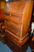 AN OAK FALL FRONT BUREAU, together with an old Charm two door cabinet (2)