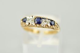 A 9CT SAPPHIRE AND DIAMOND RING designed as three graduated sapphires each interspaced by a single