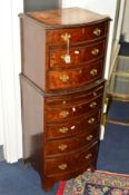A TALL NARROW REPRODUCTION BURR WALNUT CHEST of seven drawers with a central drawing slide on