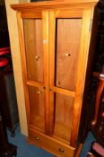 A PINE GLAZED TWO DOOR BOOKCASE and a tall CD cabinet (2)