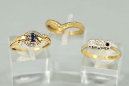 THREE RINGS to include a three stone diamond ring, centrally set with a brilliant cut diamond and