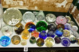 THIRTY TWO PAPERWEIGHTS OF VARYING SIZES, SHAPES AND COLOURS, some having internal air bubbles, some