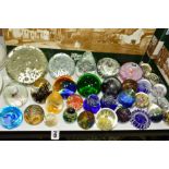 THIRTY TWO PAPERWEIGHTS OF VARYING SIZES, SHAPES AND COLOURS, some having internal air bubbles, some