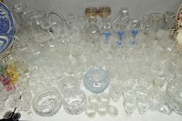 A QUANTITY OF CUT GLASS etc to include drinking glasses, bowls, vases and a tapering slab sided