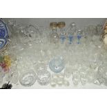 A QUANTITY OF CUT GLASS etc to include drinking glasses, bowls, vases and a tapering slab sided