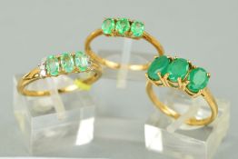 THREE 9CT GOLD EMERALD DRESS RINGS to include a three stone oval mixed cut emerald, ring size O, a