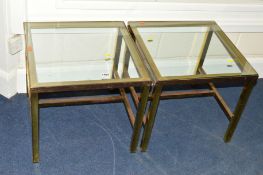 A PAIR OF SQUARE GLASS TOPPED OCCASIONAL TABLES on a brass frame, in the style of Pierre Vandal,
