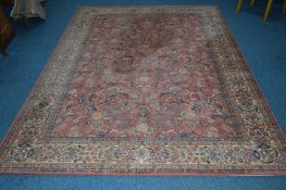 A MODERN PINK AND CREAM GROUND RUG, with a foliate design, 300cm x 300cm, together with an early
