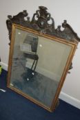A MODERN GILT FRAMED BEVELLED EDGE WALL MIRROR with foliate moulding, 93cm x 124cm (sd, losses)
