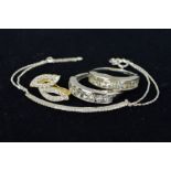 A CUBIC ZIRCONIA BRACELET, EARRING AND TWO RINGS, the bracelet designed as a thin curved bar set