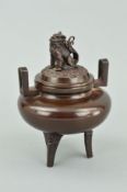 A CHINESE BRONZED KORO, with Dog of Fo finial, on three feet, impressed marks to base, approximate