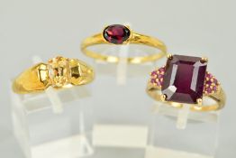 THREE 9CT GOLD GEM SET RINGS to include an oval garnet ring, ring size W 1/2, a ruby ring, the