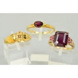 THREE 9CT GOLD GEM SET RINGS to include an oval garnet ring, ring size W 1/2, a ruby ring, the