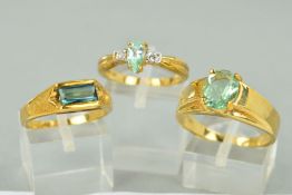 THREE 9CT GOLD AQUAMARINE DRESS RINGS to include a three stone teardrop aquamarine and white