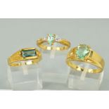 THREE 9CT GOLD AQUAMARINE DRESS RINGS to include a three stone teardrop aquamarine and white