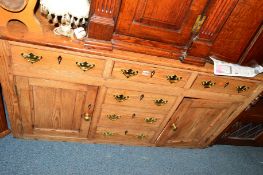 A VICTORIAN PITCH PINE DRESSER BASE with three drawers above three dummy drawers central to two
