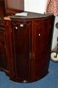 A GOERGIAN MAHOGANY AND INLAID BOWFRONT TWO DOOR HANGING CORNER CUPBOARD