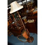 A 20TH CENTURY OAK BARLEY TWIST STANDARD LAMP with a shade
