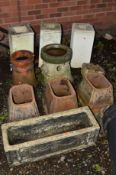 A COLLECTION OF COMPOSITE GARDEN ITEMS including three white painted columns, terracotta chimney,