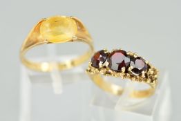 TWO 9CT GOLD GEM SET RINGS, the first designed as an oval citrine claw set to the V shape shoulders,
