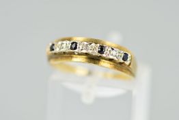 A 9CT GOLD SAPPHIRE AND DIAMOND RING, designed as a line of four circular sapphires interspaced by