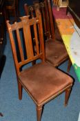 A SET OF FOUR OAK ART NOUVEAU DINING CHAIRS with overstuffed seat pads