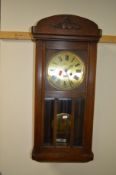 A MID 20TH CENTURY OAK WALL CLOCK