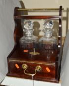 A TWO BOTTLE TANTALUS, with a compartment for two whiskey glasses, with locking key and glasses,