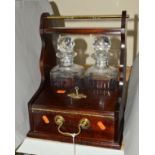 A TWO BOTTLE TANTALUS, with a compartment for two whiskey glasses, with locking key and glasses,