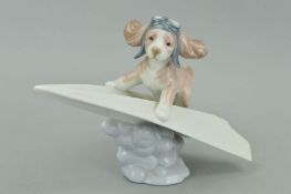 A LLADRO FIGURE, 'Let's fly Away' modelled as a dog on paper aeroplane, by Begona Jauregui,