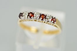 A 9CT GOLD SEVEN STONE RUBY AND DIAMOND RING designed as a line of four circular rubies