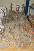 A QUANTITY OF CUT GLASS ETC, to include decanters, storage jars, drinking glasses and trinkets