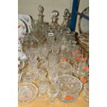 A QUANTITY OF CUT GLASS ETC, to include decanters, storage jars, drinking glasses and trinkets