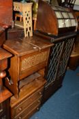 AN OAK LINENFOLD LEAD GLAZED TWO DOOR BOOKCASE (key), an oak sewing box, an oak chest of three
