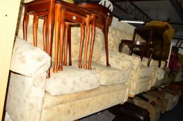 A CREAM FLORAL UPHOLSTERED THREE PIECE LOUNGE SUITE comprising of a two seater settee and a pair