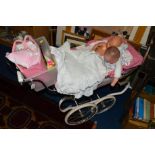 A PINK SILVER CROSS CHILD'S PRAM, together with dolls clothes etc, to include Zapfi Creation doll