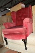 A PAIR OF UPHOLSTERED WING BACK ARMCHAIRS