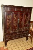 A 20TH CENTURY ORIENTAL STAINED WOOD TWO DOOR CABINET, red ground, the various panels with