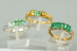 THREE 9CT GOLD EMERALD DRESS RINGS to include a white gold three stone emerald and diamond ring,