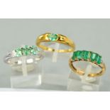 THREE 9CT GOLD EMERALD DRESS RINGS to include a white gold three stone emerald and diamond ring,