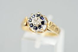 A 9CT GOLD SAPPHIRE AND DIAMOND CLUSTER RING, designed as a central single cut diamond within an