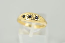 A 9CT GOLD SAPPHIRE RING, designed as three graduated circular sapphires within star settings with