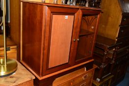 A MODERN MAHOGANY HI-FI CABINET, a wall mirror and a brassed uplighter (3)