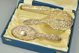 A CASED ELIZABETH II SILVER BACKED THREE PIECE DRESSING TABLE SET, late Victorian style,