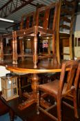 AN OAK EXTENDING DINING TABLE and four chairs (5)