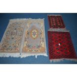 AN EARLY 20TH CENTURY WOOLLEN RUG, red ground, 85cm x 65cm, a similar rug and two Chinese style rugs